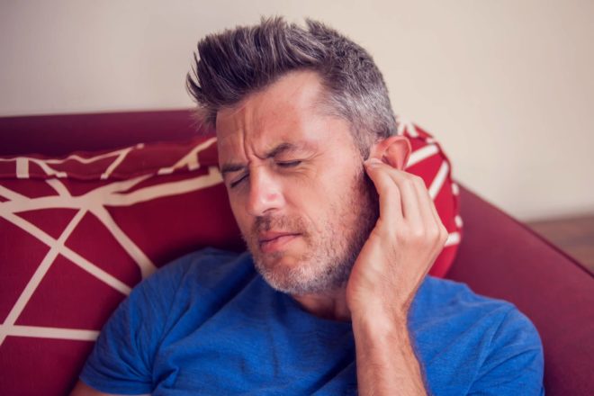 A man experiencing ear pain from tinnitus in Elkhart Indiana.